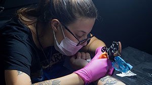 female-tattoo-artist-working